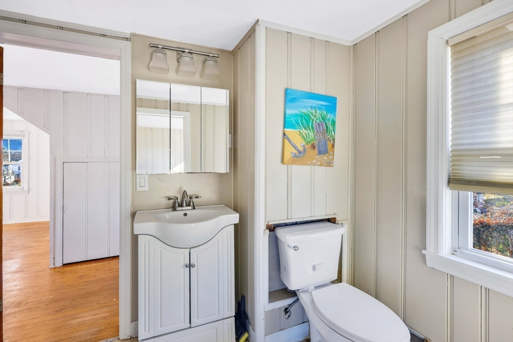 104 Oregon Street Springfield, MA 01118 - Photo 27 of 32 a bathroom with a sink a toilet and mirror