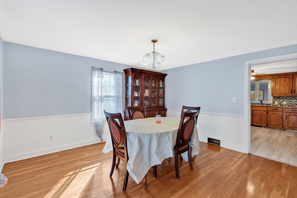 104 Oregon Street Springfield, MA 01118 - Photo 7 of 32 a view of a dining room with furniture window and wooden floor