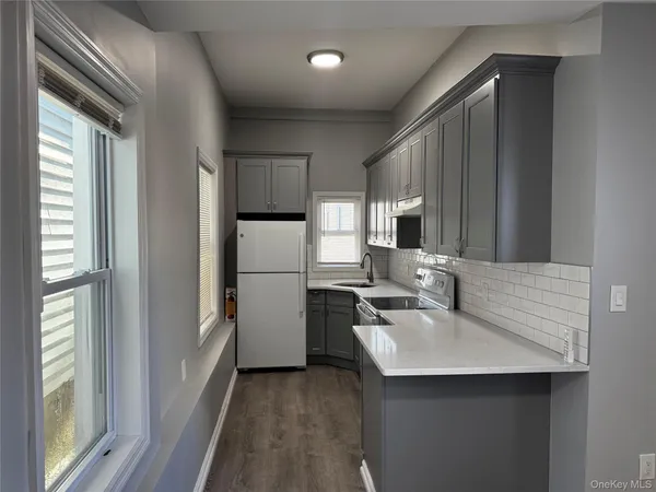 a kitchen with refrigerator cabinets and furniture