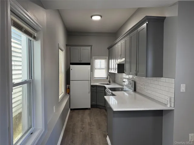 a kitchen with refrigerator cabinets and furniture