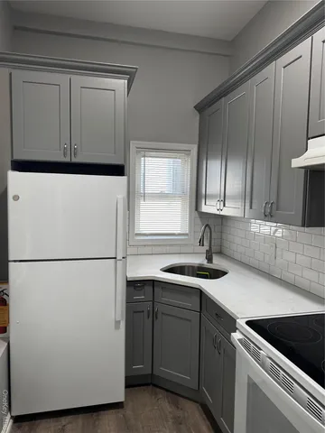 a kitchen with a refrigerator and a sink