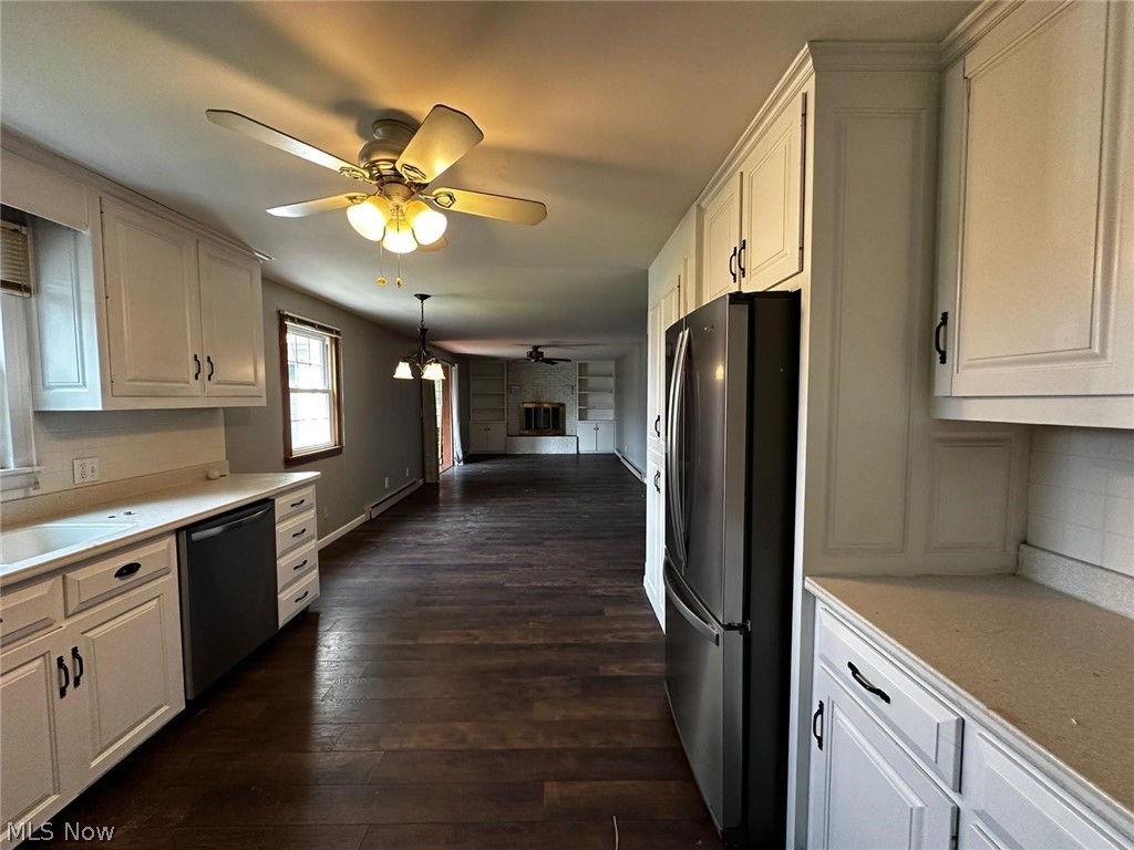 2093 Cambridge Road Coshocton, OH 43812 - Photo 14 of 32 Kitchen with ceiling fan, white cabinets, black dishwasher, dark hardwood / wood-style floors, and stainless steel refrigerator
