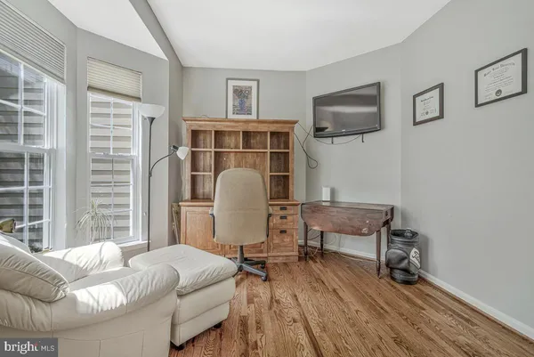 a living room with furniture and a ceiling fan