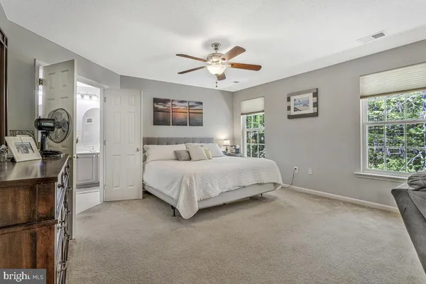 a bedroom with furniture and a lamp