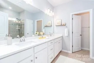 a bathroom with a double vanity sink and mirror