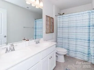 a bathroom with a sink a toilet and mirror