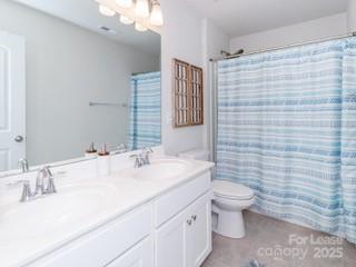 4268 Coachwhip Avenue, Unit 92 Lancaster, SC 29720 - Photo 27 of 36 a bathroom with a sink a toilet and mirror