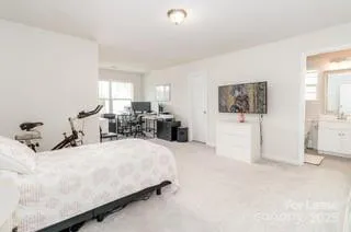 a bedroom with a bed and white cabinets