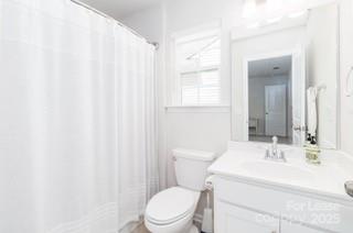 4268 Coachwhip Avenue, Unit 92 Lancaster, SC 29720 - Photo 32 of 36 a bathroom with a sink a toilet and a mirror