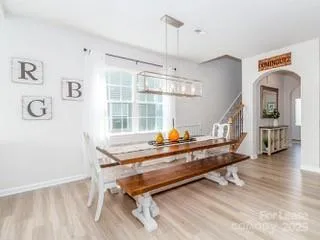 a view of a room with wooden floor and furniture