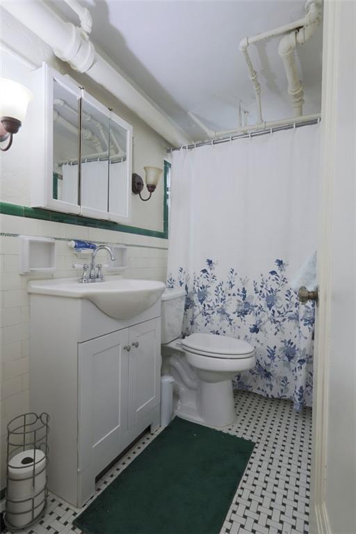 50 Academy Avenue, Unit 31 Pittsburgh, PA 15228 - Photo 13 of 13 a bathroom with a sink a toilet and mirror