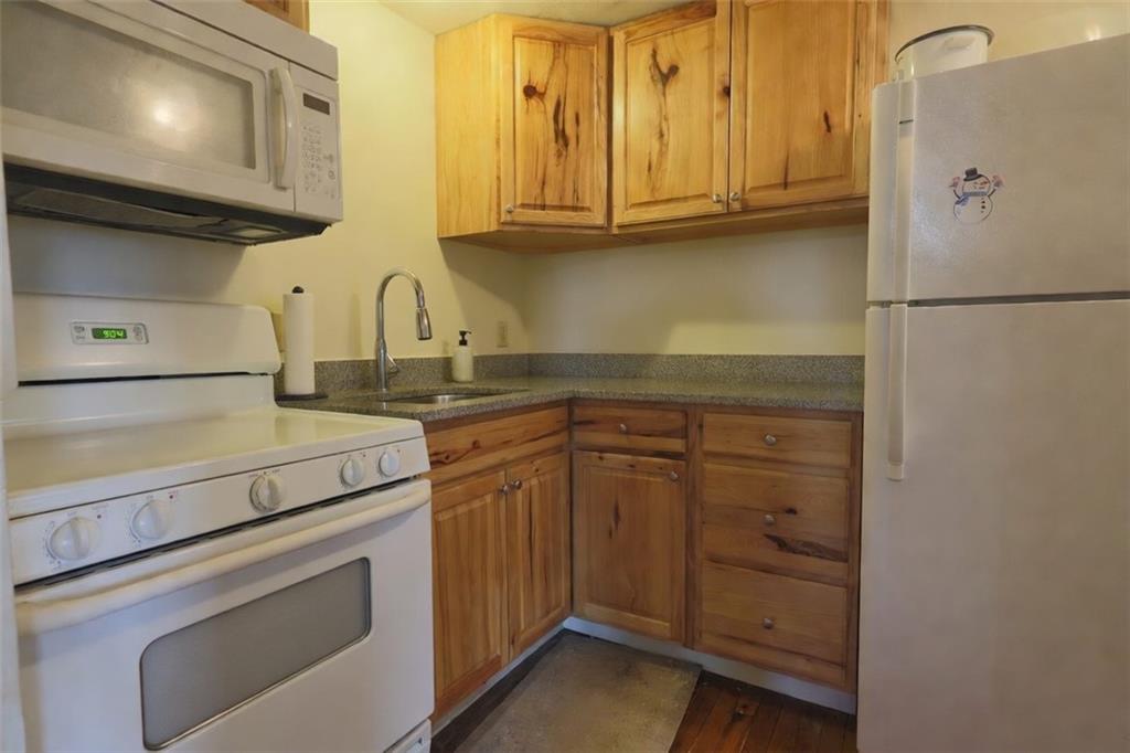 50 Academy Avenue, Unit 31 Pittsburgh, PA 15228 - Photo 8 of 13 a kitchen with stainless steel appliances granite countertop a sink and a refrigerator