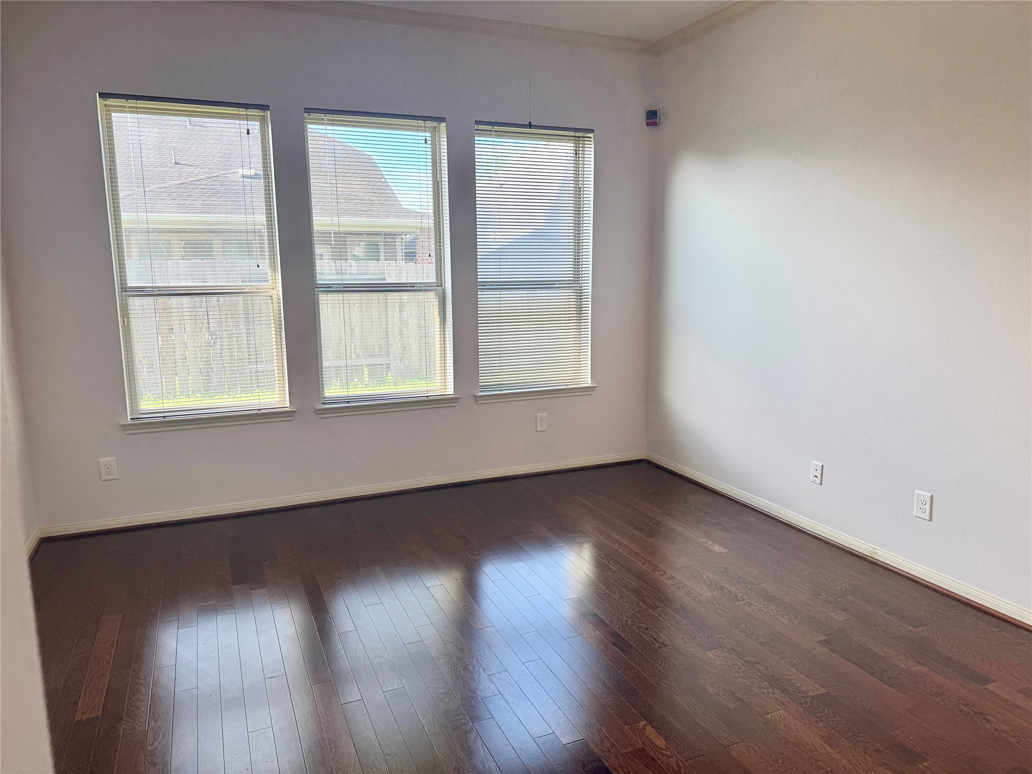 12407 Point Arbor Court Tomball, TX 77377 - Photo 12 of 18 an empty room with wooden floor and windows