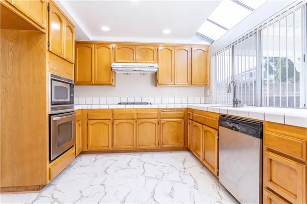 a view of a kitchen with countertop cabinets and outdoor space