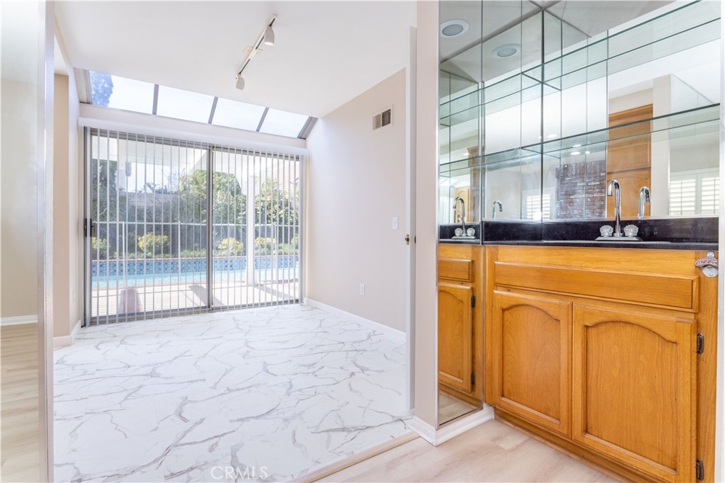 12067 Turtle Springs Court Porter Ranch, CA 91326 - Photo 12 of 34 a view of a kitchen with countertop cabinets and outdoor space