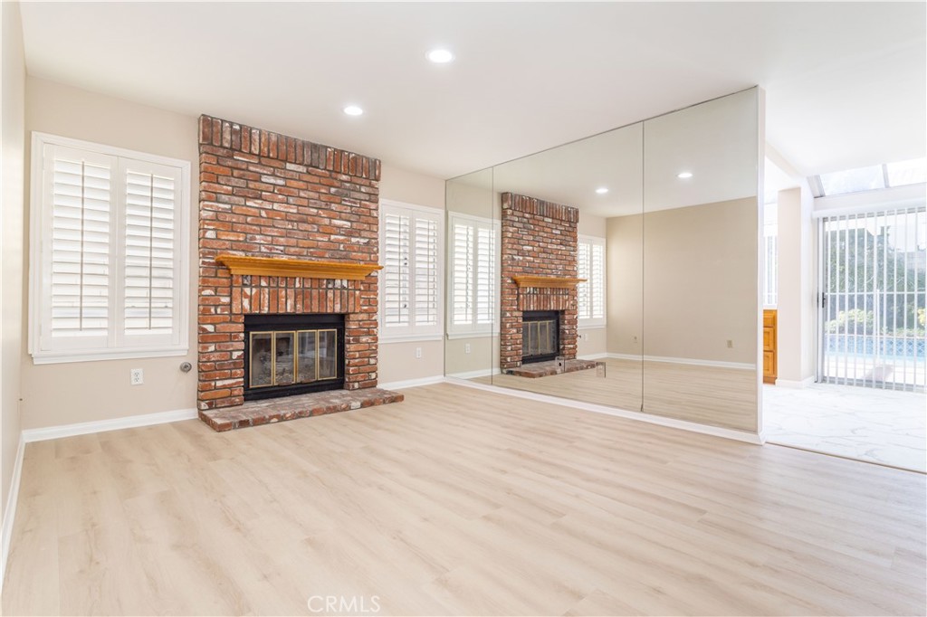 12067 Turtle Springs Court Porter Ranch, CA 91326 - Photo 14 of 34 a view of empty room with fireplace and wooden floor