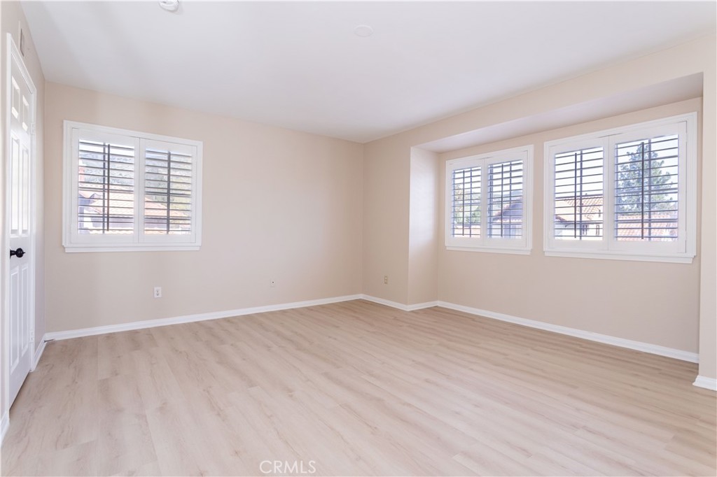 12067 Turtle Springs Court Porter Ranch, CA 91326 - Photo 17 of 34 an empty room with wooden floor and windows