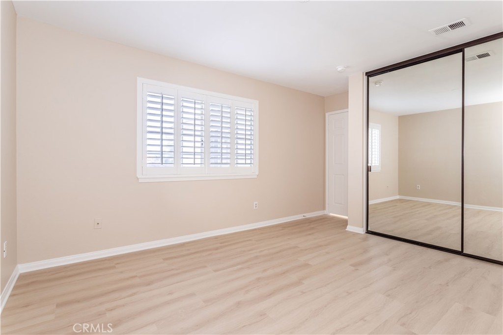 12067 Turtle Springs Court Porter Ranch, CA 91326 - Photo 19 of 34 an empty room with wooden floor and sliding door