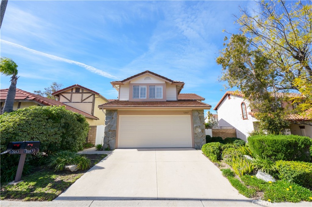 12067 Turtle Springs Court Porter Ranch, CA 91326 - Photo 2 of 34 a front view of a house with a yard and garage
