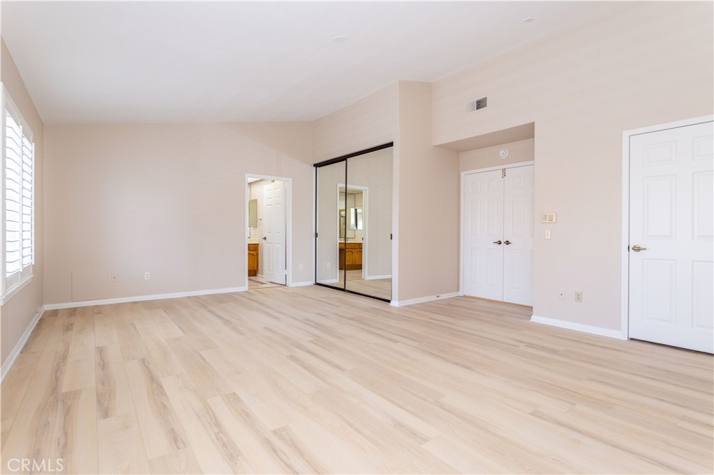 12067 Turtle Springs Court Porter Ranch, CA 91326 - Photo 22 of 34 a view of an empty room with wooden floor and a window