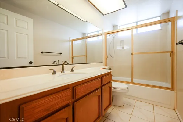 a spacious bathroom with a double vanity sink and a mirror