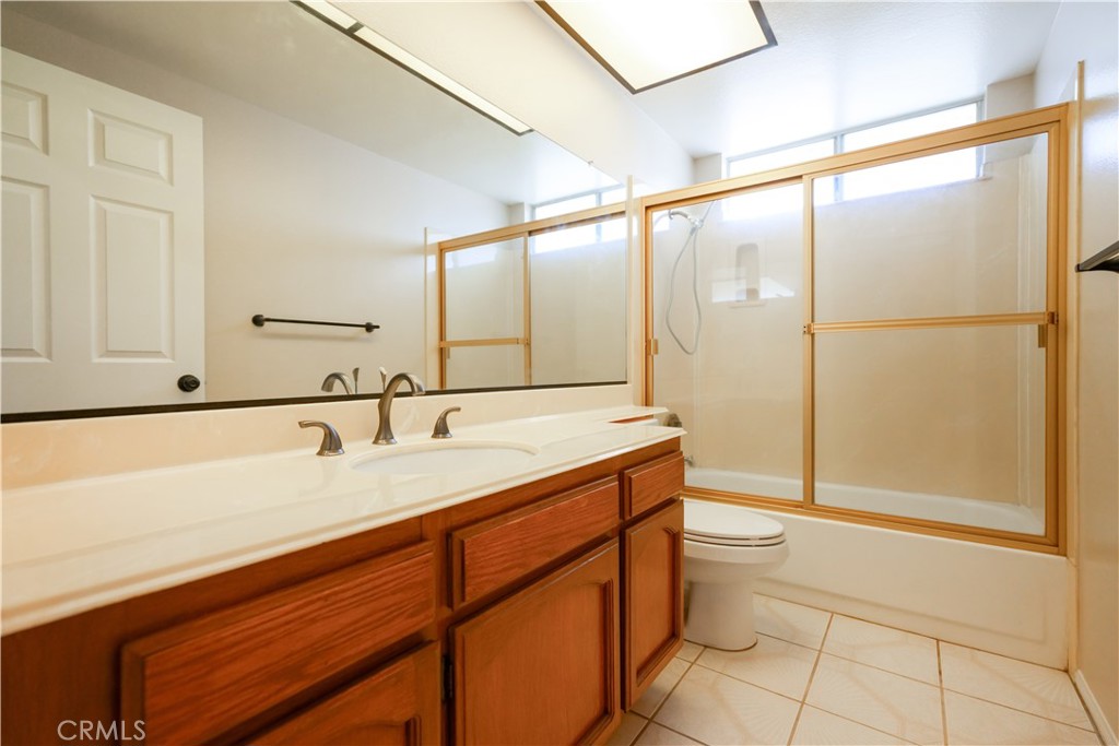 12067 Turtle Springs Court Porter Ranch, CA 91326 - Photo 25 of 34 a bathroom with a granite countertop sink mirror vanity and toilet