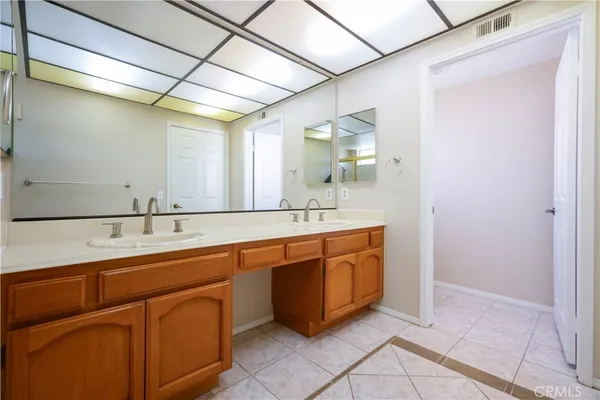 a bathroom with a granite countertop toilet a sink and a mirror