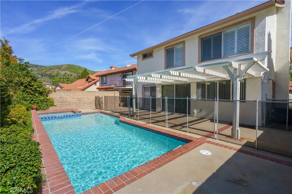 12067 Turtle Springs Court Porter Ranch, CA 91326 - Photo 30 of 34 a view of a house with backyard porch and sitting area