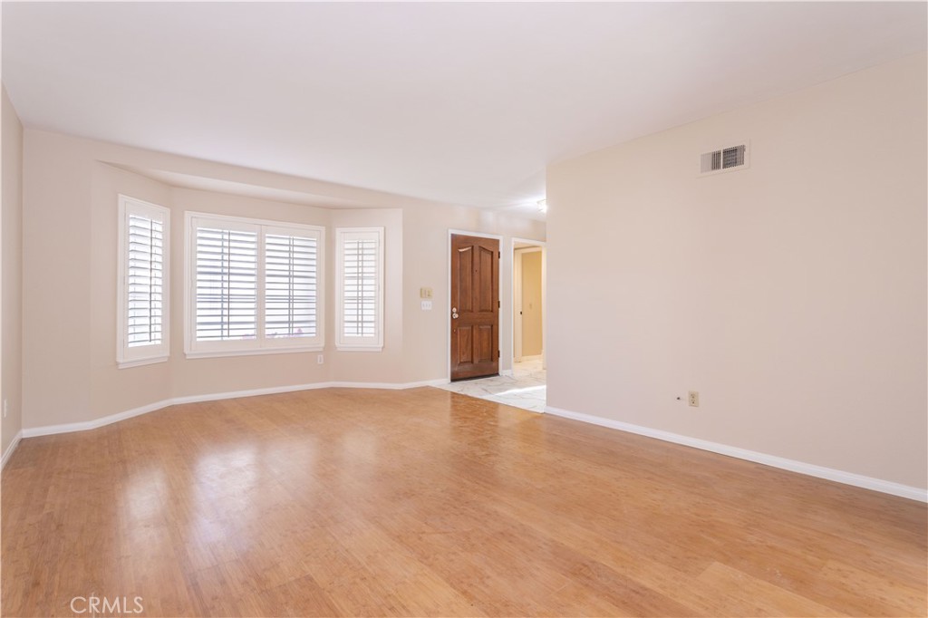 12067 Turtle Springs Court Porter Ranch, CA 91326 - Photo 4 of 34 wooden floor in an empty room with a window