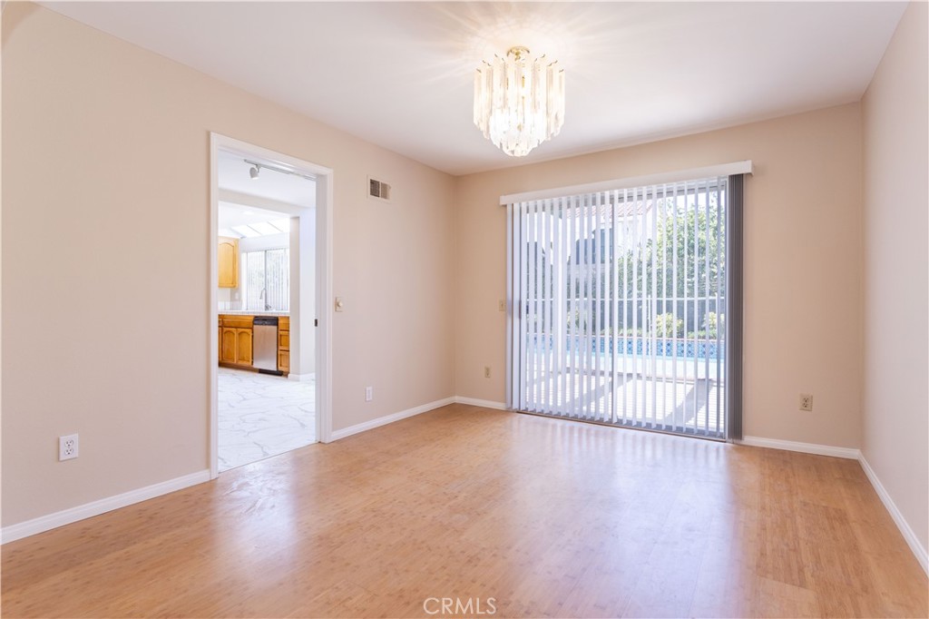 12067 Turtle Springs Court Porter Ranch, CA 91326 - Photo 5 of 34 a view of an empty room with wooden floor and a window