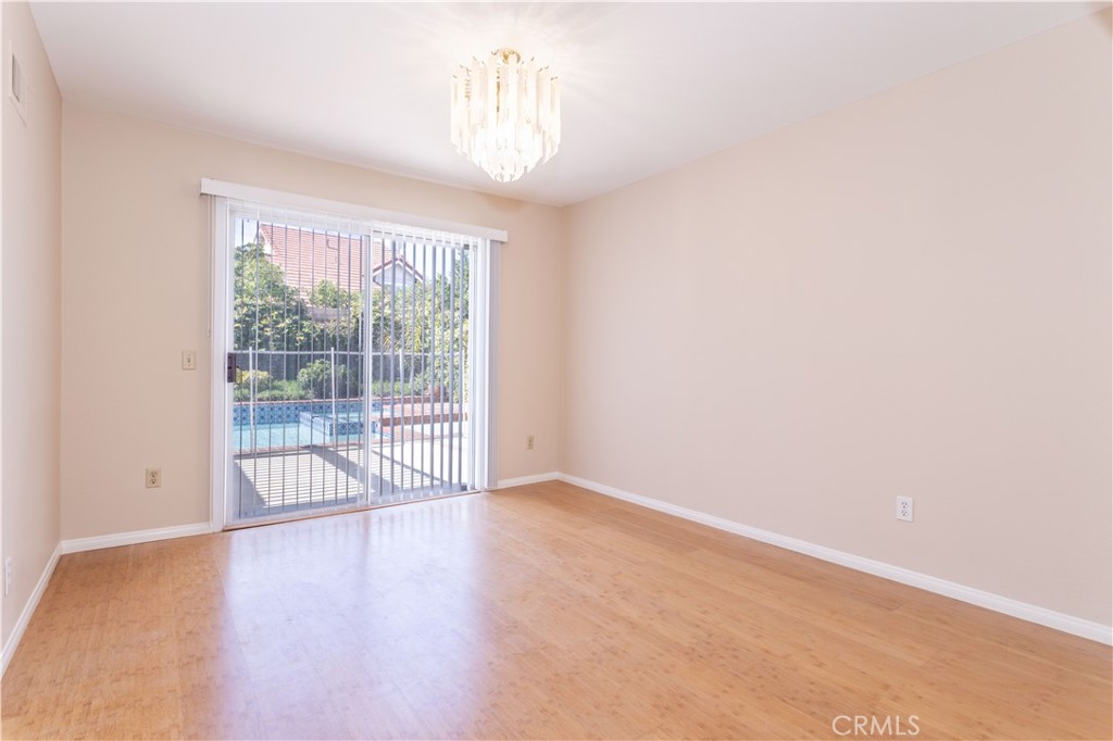 12067 Turtle Springs Court Porter Ranch, CA 91326 - Photo 6 of 34 an empty room with wooden floor and windows