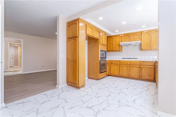 a kitchen with stainless steel appliances granite countertop a sink and cabinets