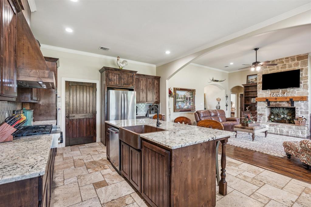 4180 North Smith Road Fate, TX 75087 - Photo 10 of 27 a kitchen with a sink a counter top space and stainless steel appliances