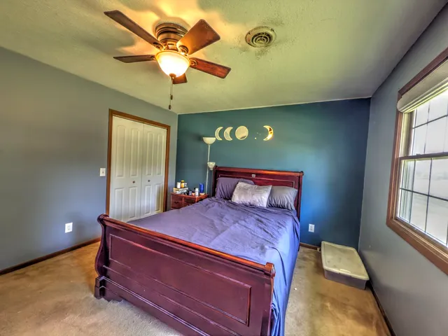 a bedroom with a bed and window