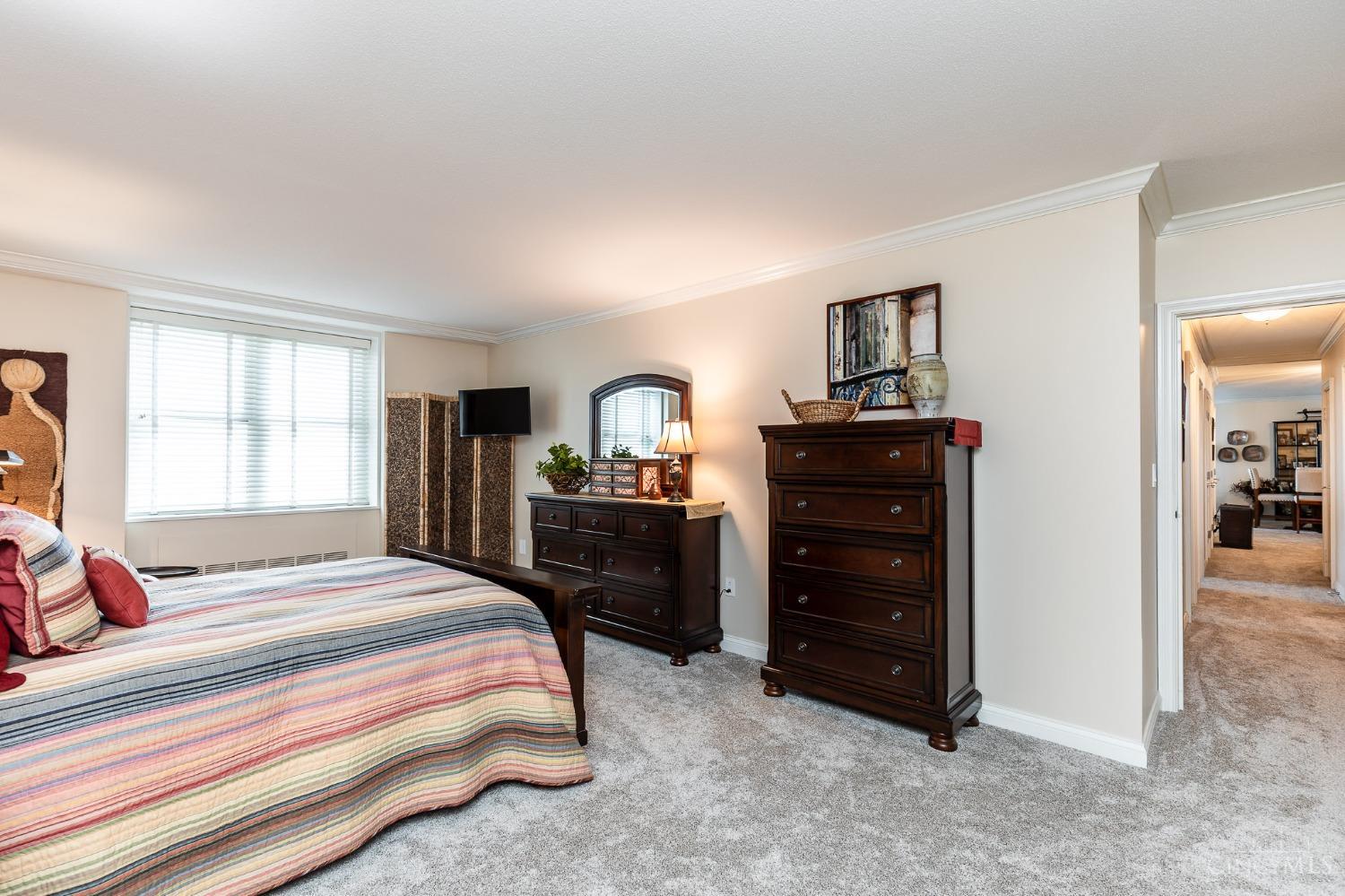 2444 Madison Road, Unit 901 Cincinnati, OH 45208 - Photo 17 of 44 The expansive owner's suite boasts a large bedroom with wall-to-wall carpet, a dressing area, two sizable walk-in closets and an ensuite bath.