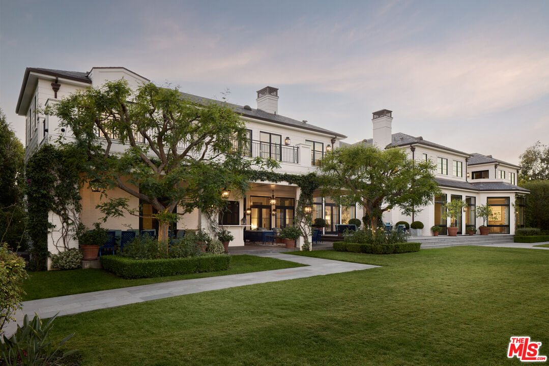 a front view of building with yard and green space