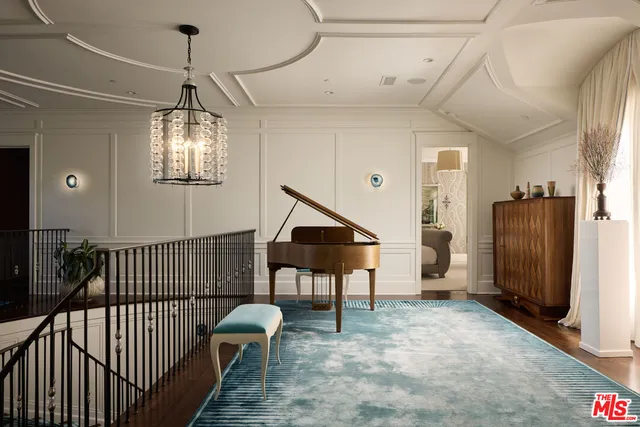 a view of a livingroom with furniture and staircase