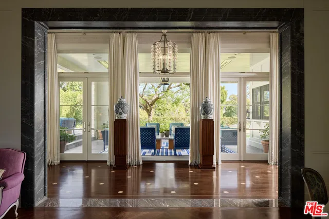 a view of a living room and floor to ceiling windows