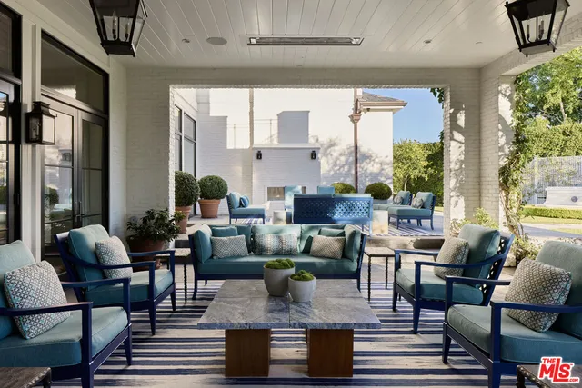 a living room with fireplace furniture and a large window