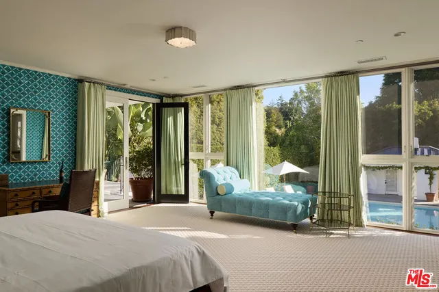 a bedroom with a bed and glass window