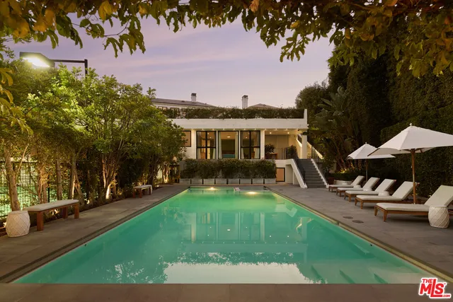 a view of a house with swimming pool and sitting area