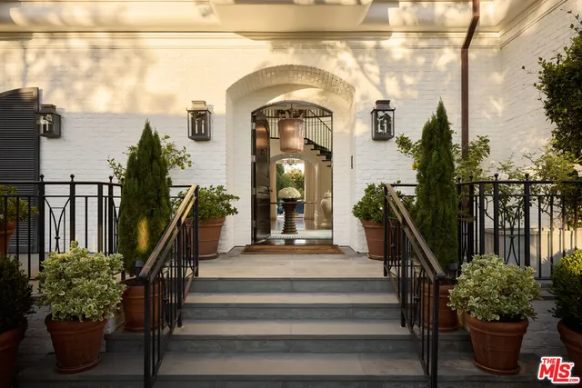 a view of a entrance gate of a house with wooden floor