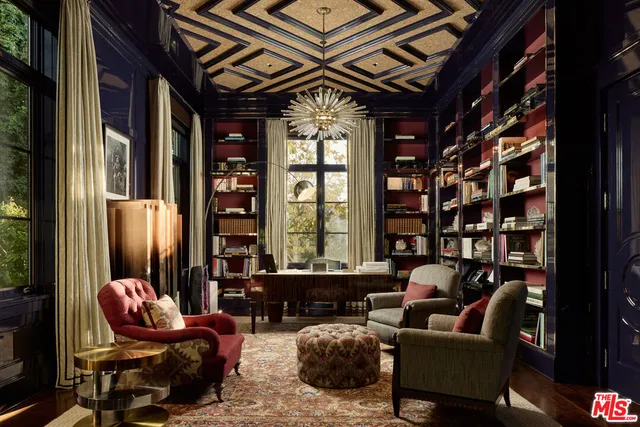 a living room with furniture a chandelier and a floor to ceiling window