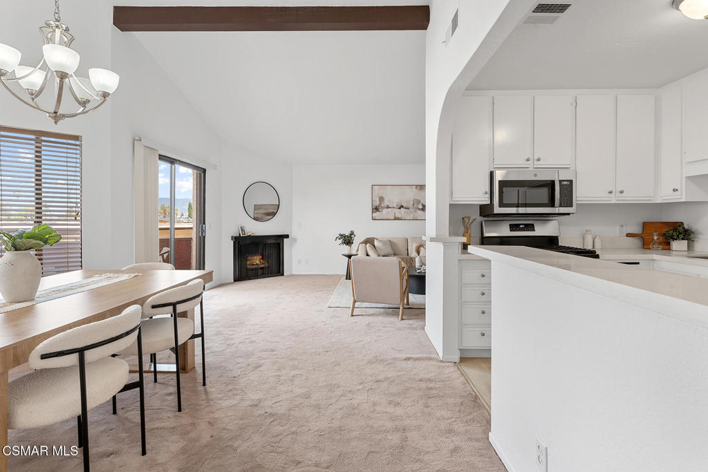 a living room with furniture a fireplace and flat screen tv