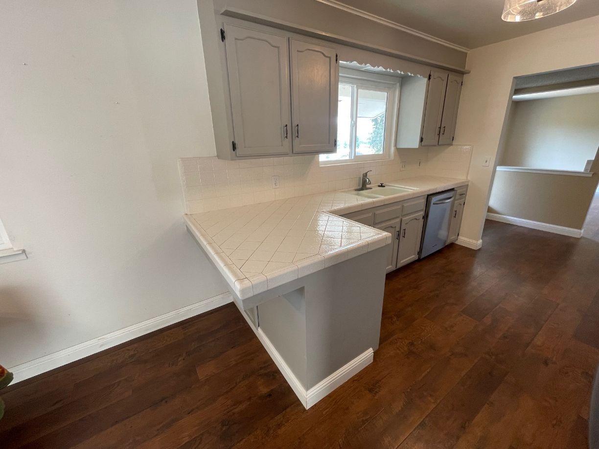 25187 Auberry Road Clovis, CA 93619 - Photo 13 of 58 a view of a kitchen area with furniture and wooden floor