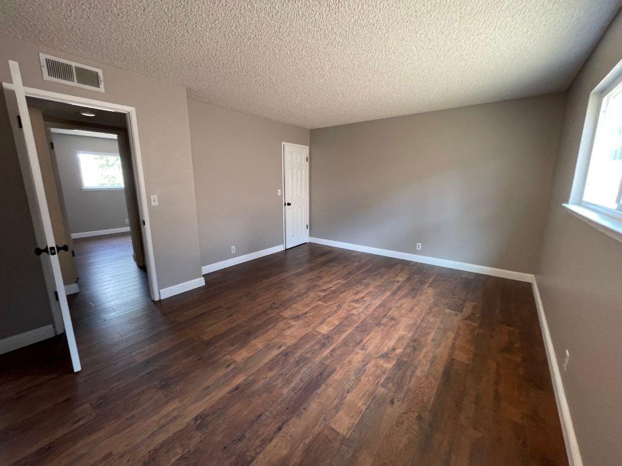 25187 Auberry Road Clovis, CA 93619 - Photo 25 of 58 an empty room with wooden floor and a window