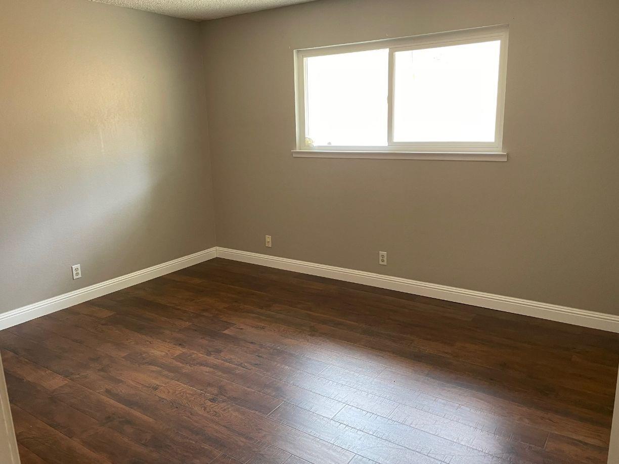 25187 Auberry Road Clovis, CA 93619 - Photo 27 of 58 an empty room with wooden floor and windows