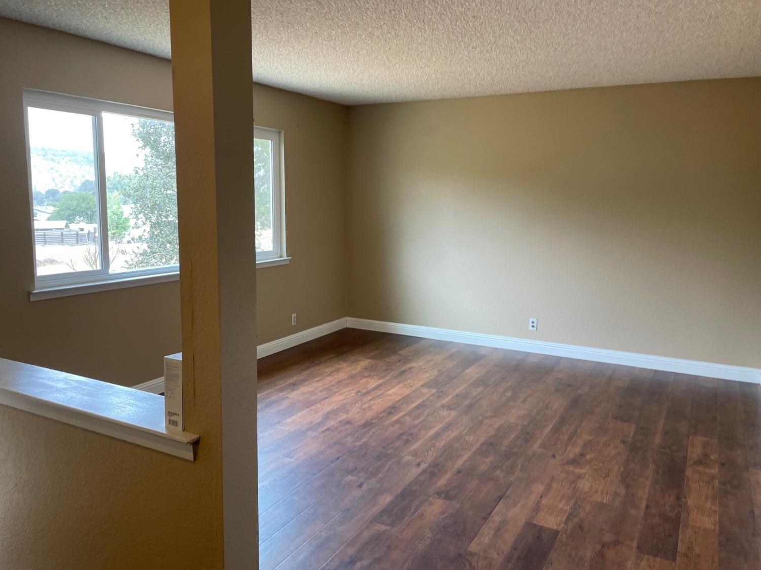25187 Auberry Road Clovis, CA 93619 - Photo 49 of 58 an empty room with wooden floor and windows