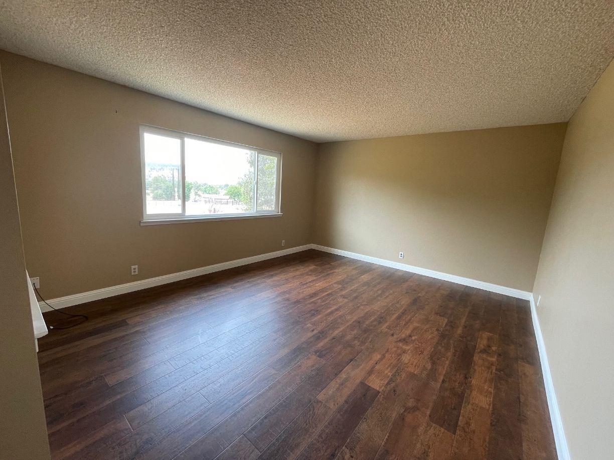25187 Auberry Road Clovis, CA 93619 - Photo 9 of 58 an empty room with wooden floor and windows