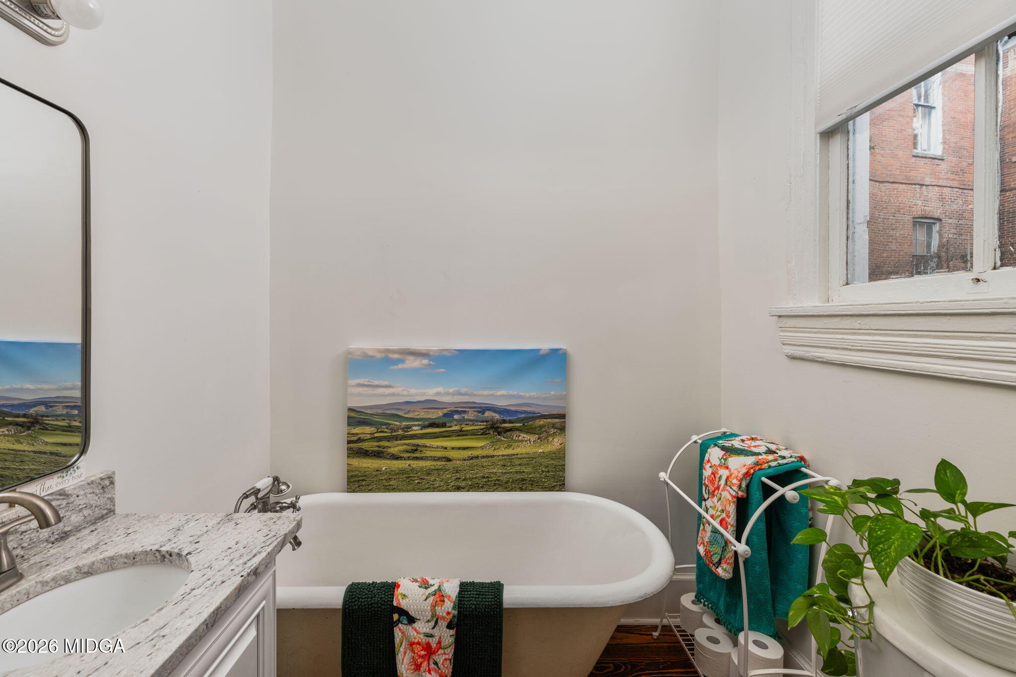 417 Orange Street Macon, GA 31201 - Photo 14 of 49 a bathroom with a granite countertop sink and a bathtub